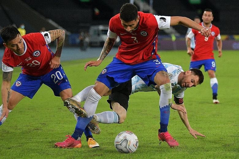 Argentina's Lionel Messi vying for the ball with Chile's Charles Aranguiz (left) and Guillermo Maripan at the Nilton Santos Stadium. The Barcelona forward scored his 73rd international goal in the 1-1 draw.