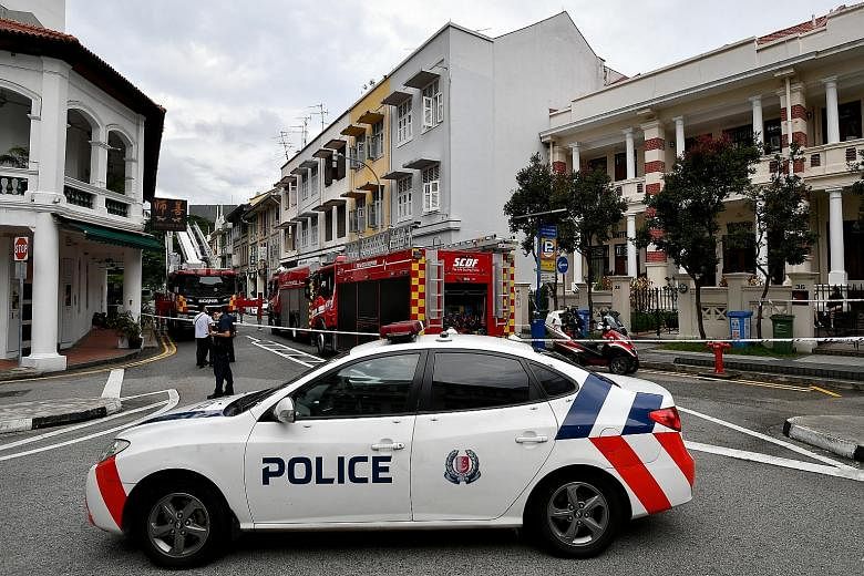 Yesterday morning's fire engulfed the ceiling on the third storey and attic of a shophouse at 31 Teo Hong Road in Outram Park. Two firefighters were on the third storey of the shophouse when parts of the ceiling fell on them.