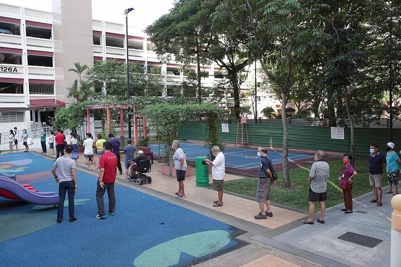 Two queues formed at Block 125A Bukit Merah View after the temporary testing site was opened to residents yesterday. One was for people who had made an appointment. The second queue, for people who had not made an appointment, snaked past the estate'