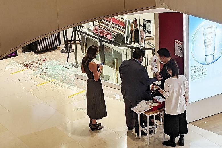 A glass panel at make-up store Bobbi Brown shattered yesterday, leaving a store assistant with cuts on his arms. He was opening the store for the day when the incident happened. ST PHOTO: CHARMAINE NG