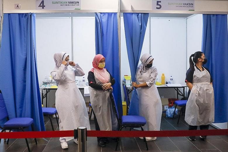 Nurses waiting to administer Covid-19 vaccines to residents last week in Bukit Jalil, outside Kuala Lumpur. The Malaysian government aims to get a 50 per cent Covid-19 vaccination rate in Kuala Lumpur and Selangor by July, and the same rate for Johor