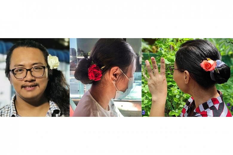 Myanmar rights activist Thet Swe Win (left) was among those who wore flowers in their hair yesterday to mark the 76th birthday of detained leader Aung San Suu Kyi.