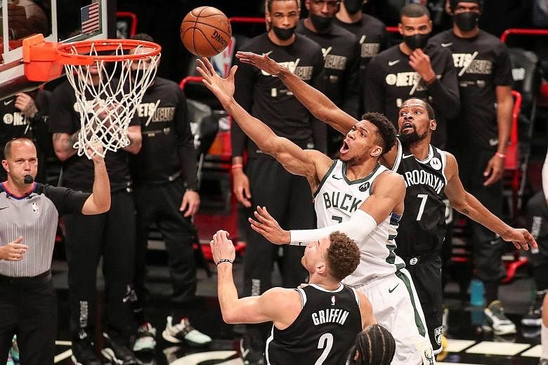 Milwaukee Bucks' Giannis Antetokounmpo driving past Brooklyn Nets' Kevin Durant during the Bucks' 115-111 win on Saturday. Milwaukee are through to the Eastern Conference Finals.