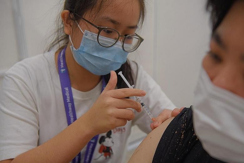 A nurse administering a Covid-19 shot at a vaccination centre here. Since vaccination bookings were opened to citizens aged 12 to 39 earlier this month, measures adopted by companies to urge their staff to get their jabs have taken on a new urgency.