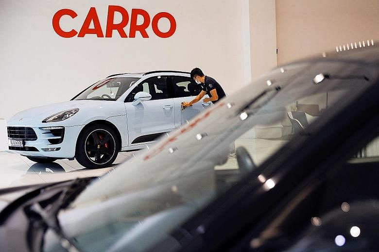Above: Carro co-founder and chief executive Aaron Tan believes his start-up has a home-grown advantage in the region. Left: Carro's showroom in Singapore. Its platform allows consumers and businesses to buy and sell vehicles while also providing fina