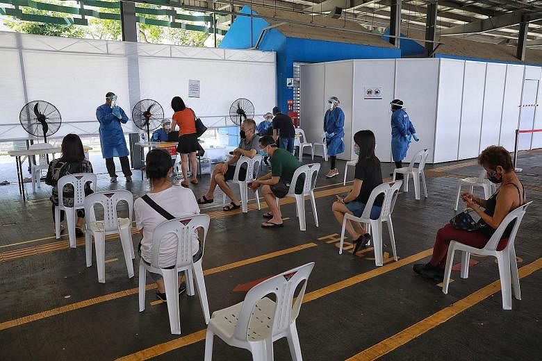 People waiting for their turn at a quick test centre in Yishun Central yesterday. This centre and another one in Tekka Lane have been set up ahead of a mandatory regular Covid-19 testing regime for individuals who work in higher-risk settings. ST PHO