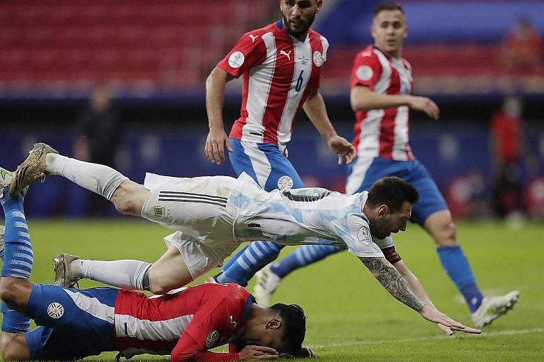 Argentina's Lionel Messi falling over Paraguay's Gustavo Gomez during his side's 1-0 win on Monday to qualify for the Copa America quarter-finals with a group game to spare.