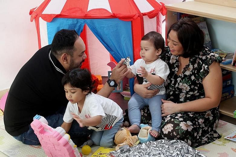 Madam Shariffah Dayana Syed Hassan Al-Yahya and Mr Andri Panusunan Sagala, both 38, with their sons, three-year-old Rumi and one-year-old Aria. Children benefiting from SP Group's donation will receive educational tools, books and toys in the form of