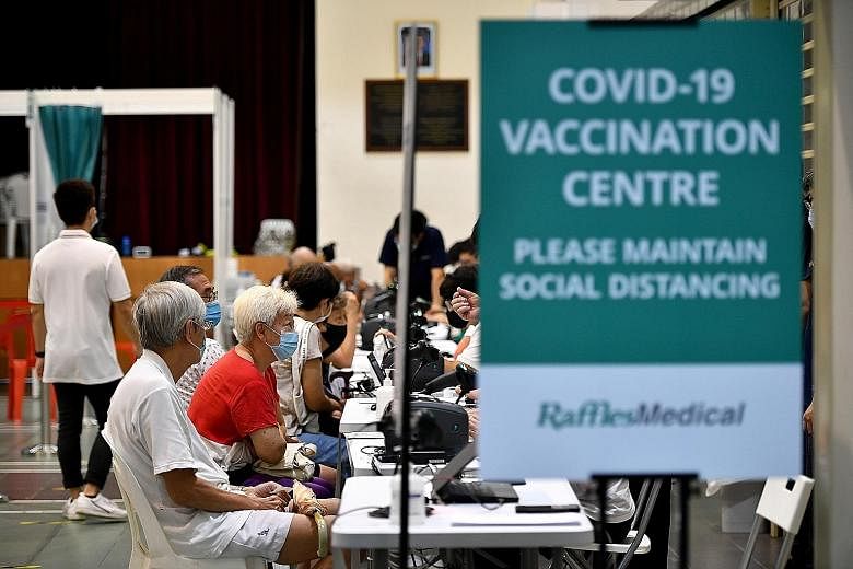 People at the Covid-19 vaccination centre in Hong Kah North Community Club in March. On Thursday, Health Minister Ong Ye Kung said about 75 per cent of people aged 60 and older had received at least one dose of the vaccine, but this was "not enough".