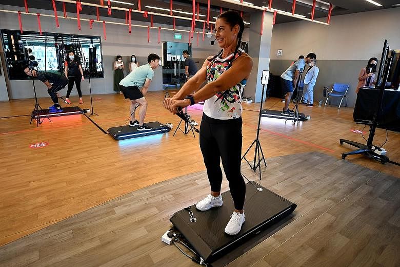 Vitruvian ambassador Natalie Dau demonstrating the use of the V-Form Trainer along with members of the media and Fitness First staff at Bugis Junction on Wednesday.