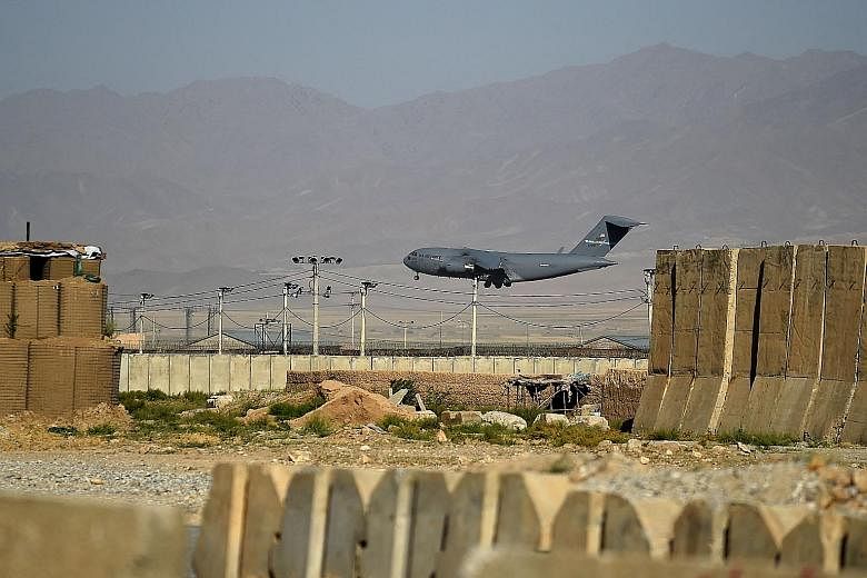 A US military plane landing at Bagram Air Base, about 60km north of the Afghan capital Kabul, this week. The withdrawal of American forces from the base symbolises the end of US military involvement in Afghanistan. PHOTO: AGENCE FRANCE-PRESSE