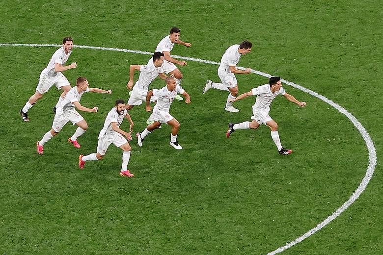 The Spain squad celebrating after winning their penalty shoot-out against Switzerland 3-1 in St Petersburg, Russia, to set up a semi-final against Italy. PHOTO: EPA-EFE