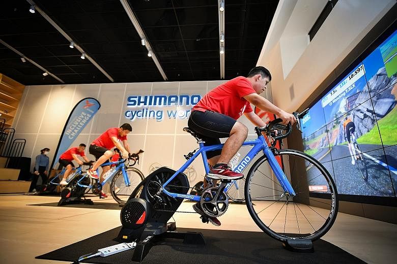 YMCA Strong ambassador Ryan Yap taking part in the YMCA Special Needs Cycling Challenge at Shimano Cycling World to raise funds and awareness for those with special needs yesterday. He and four others, including SNOC president Tan Chuan-Jin (centre) 