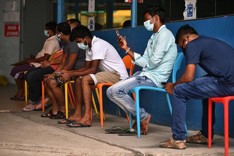Mr Selvarasu Mohanraj, 30, an Indian migrant worker, having his temperature taken. Patients are triaged upon arrival before being ushered to the registration counter at the regional medical centre at 63 Loyang Way. Workers waiting outside the medical