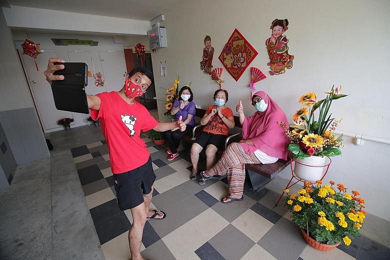 Mr Abdullah Abdul Rahman, 36, a resident of Tampines Street 11, taking a wefie with his neighbours - (from far left) Madam Chen, 70, who did not want to give her full name, Madam Mary Tay, 70, and Madam Rasida A. Rahman, 62 - in February, just before
