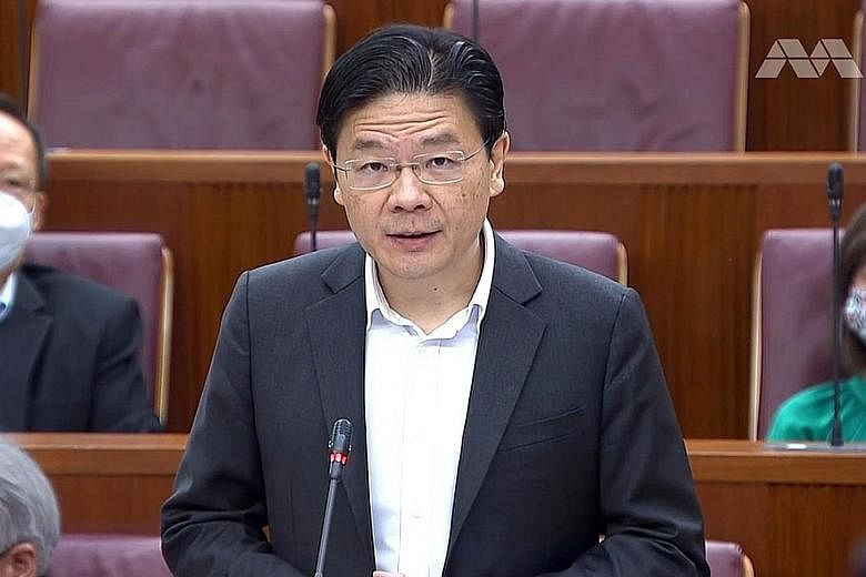 Finance Minister Lawrence Wong addressing Parliament. About half of the $1.2 billion will come from what was originally budgeted for the Deep Tunnel Sewerage System and the North-South Corridor. The rest will be reallocated from the under-utilisation