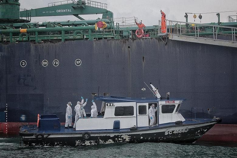 Crew members leaving oil tanker STI Carnaby for Marina South Pier in June last year, after having sailed for months because of border closures. Singapore is one of the first countries to prioritise the safety of seafarers by, for instance, creating "