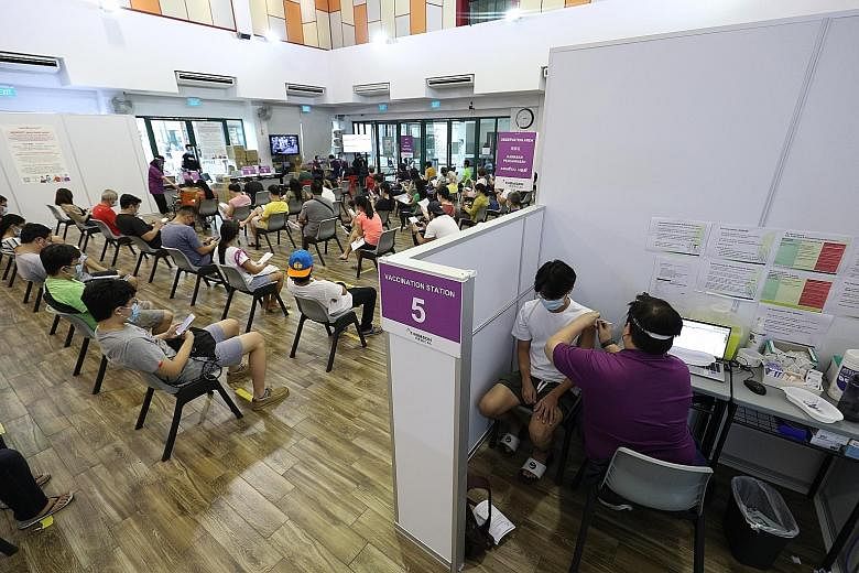 Students getting their Covid-19 jabs at the vaccination centre at Bishan Community Club last month. Health Minister Ong Ye Kung said that those who are fully vaccinated are likely to need booster shots as the vaccines are effective for between one an