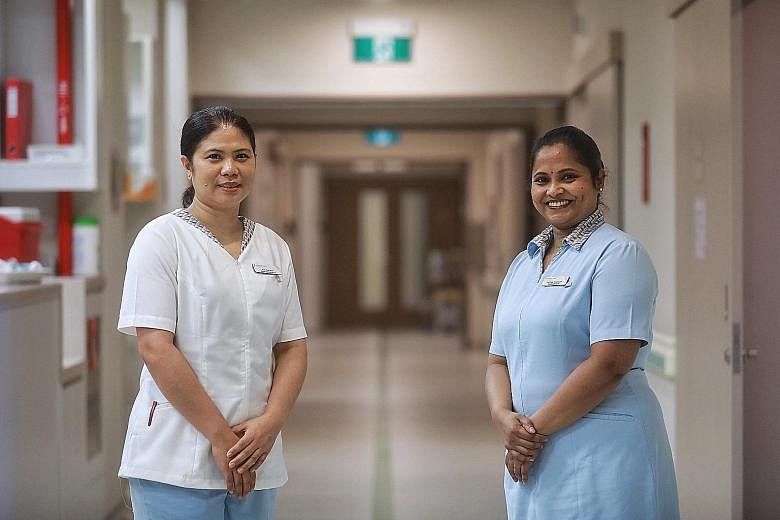 Ms Aye Aye Mon, 41, a senior enrolled nurse from Myanmar, and Mrs Karthiga Vinayagam, 44, a senior staff nurse from India, at Farrer Park Hospital. ST PHOTO: KEVIN LIM