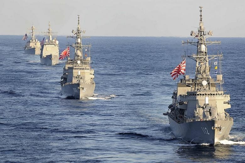 Japanese and American navy vessels passing through the western Pacific Ocean in 2017 as part of a military exercise. Japan has been instrumental in corralling friendly nations to deploy warships to the Indo-Pacific, and just last week held its first 