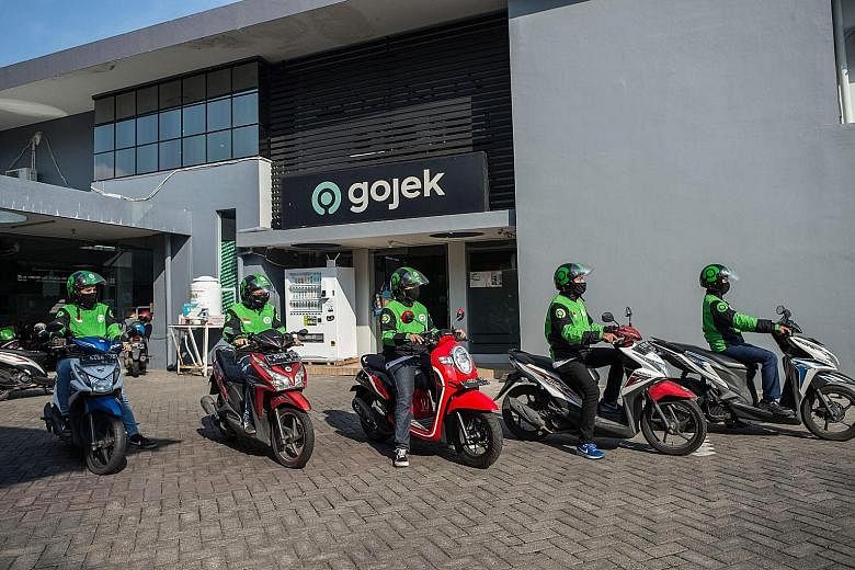 Start-up giants GoTo - the merged entity of Tokopedia and Gojek (left) - and Grab (right) seek to make online investing in mutual funds in Indonesia a fast and easy experience, like it is with their ride-hailing and food delivery services. GoTo-backe
