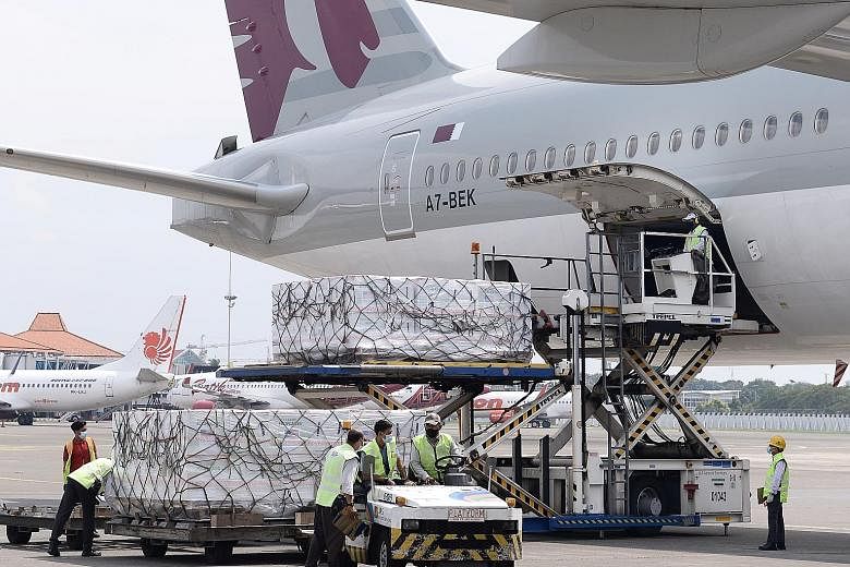 Workers at Indonesia's Soekarno Hatta International Airport in Tangerang unloading Moderna vaccines on Sunday. The vaccines come through the international Covax facility