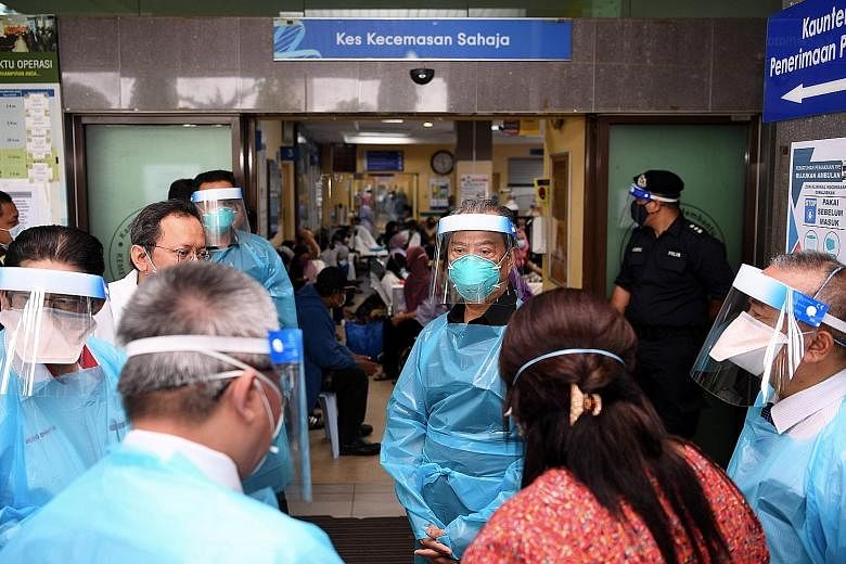 Prime Minister Muhyiddin Yassin (facing camera) visiting a hospital emergency ward treating Covid-19 patients in Klang, Selangor, on Tuesday.