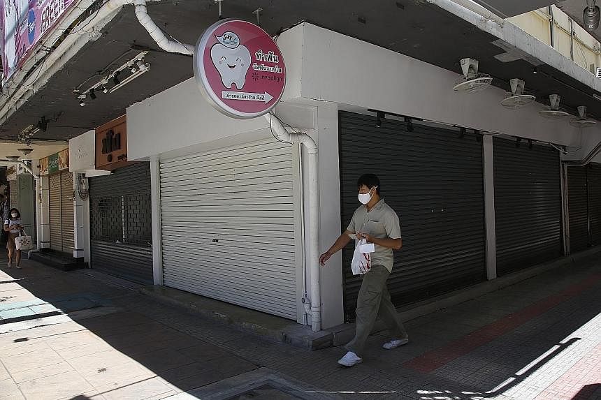 Closed stores at a shopping mall in Jakarta. The Indonesian Shopping Centre Management Association said tens of thousands of jobs are at risk if the country's lockdown extends past July 20. PHOTO: REUTERS Shuttered shops at the major business distric