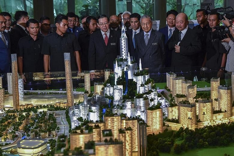 A 2019 photo of then Premier Mahathir Mohamad and other Malaysian officials looking at a model of the Bandar Malaysia development.