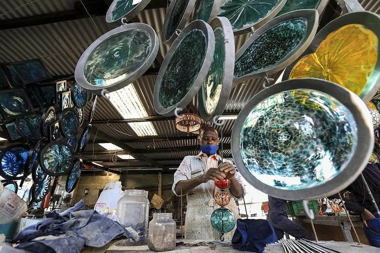 Glass is heated and moulded by artisans at Kenya's Kitengela Hot Glass studio in Tuala, Kajiado. Founded by Britain-born glass artist Anselm Croze, the studio turns glass scraps into objects such as furniture and art. The studio says it melts 150kg o