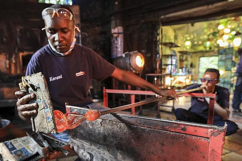 Glass is heated and moulded by artisans at Kenya's Kitengela Hot Glass studio in Tuala, Kajiado. Founded by Britain-born glass artist Anselm Croze, the studio turns glass scraps into objects such as furniture and art. The studio says it melts 150kg o