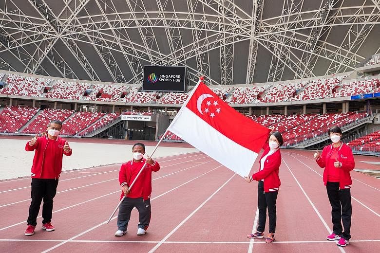 From left: Minister for Culture, Community and Youth Edwin Tong, shot putter and flag-bearer Muhammad Diroy Noordin, chef de mission Shirley Low and SNPC chairman Teo-Koh Sock Miang at yesterday's Paralympics flag presentation ceremony at the Nationa