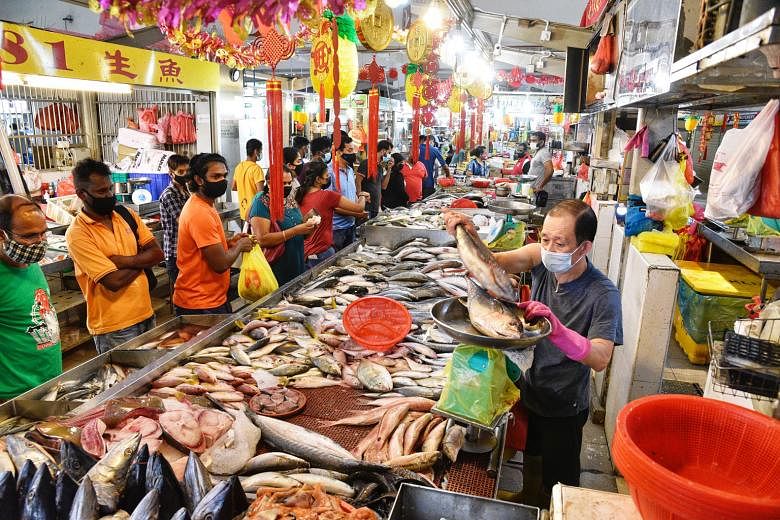 The seafood section of FairPrice Finest in Bedok Mall yesterday. A FairPrice spokesman told The Sunday Times the supermarket chain was working with suppliers to explore alternatives and ramp up fish supplies. The crowd at Tekka Market yesterday. The 