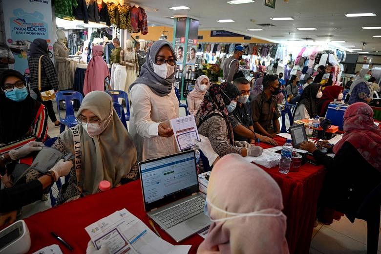 People registering to receive a dose of the Sinovac vaccine at a shopping centre in Banda Aceh, the capital of Aceh province, yesterday. PHOTO: AGENCE FRANCE-PRESSE