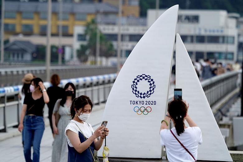 People using umbrellas to shield themselves from the sun in Tokyo last Monday. Adding to the Covid-19 crisis, hundreds of people in the Japanese capital were taken to hospital last week with heatstroke. Part of the Olympic Village in Tokyo built to h