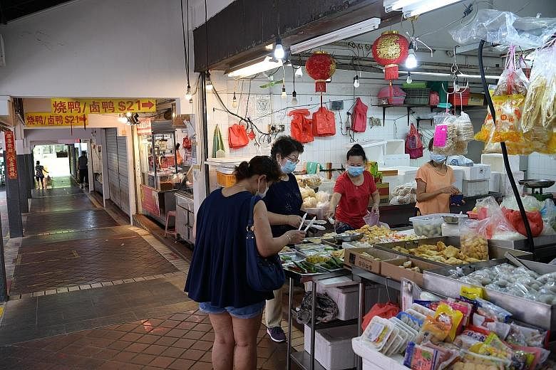 Above: A stall at a wet market in Teck Whye yesterday. People have been advised to avoid crowds at food centres and markets, visit during off-peak hours, and strictly observe safety measures. ST PHOTO: NG SOR LUAN Left: Mr Noor Abdul Aziz, 74, who se