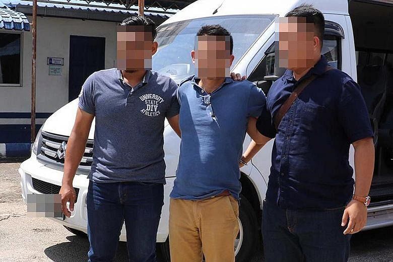 Singaporean Mohamed Kazali Salleh (centre) was arrested by Malaysian Special Branch officers in December 2018. He was deported to Singapore and issued an Order of Detention under the ISA in January 2019 for his support of the Islamic State in Iraq an