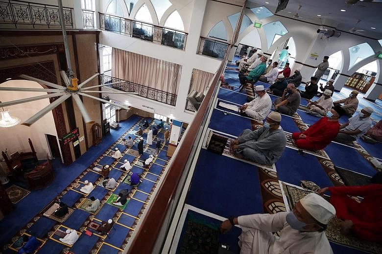 Congregants arriving at Al-Istighfar Mosque yesterday for Hari Raya Haji congregational prayers having their online bookings checked at the entrance. They had to make the bookings online from last Friday to secure a space. Each congregant at Al-Istig