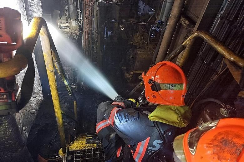 Firefighters from the Singapore Civil Defence Force putting out a blaze that broke out on a tugboat berthed in West Coast on Tuesday afternoon. PHOTO: SINGAPORE CIVIL DEFENCE FORCE/FACEBOOK