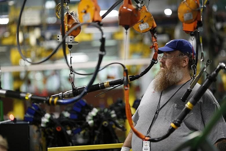 An employee working to manufacture diesel truck engines at a plant in Columbus, Indiana, in the United States. For the world economy, and for Singapore, in the age of silicon and software no less than in the age of rubber and tin, decoupling from the