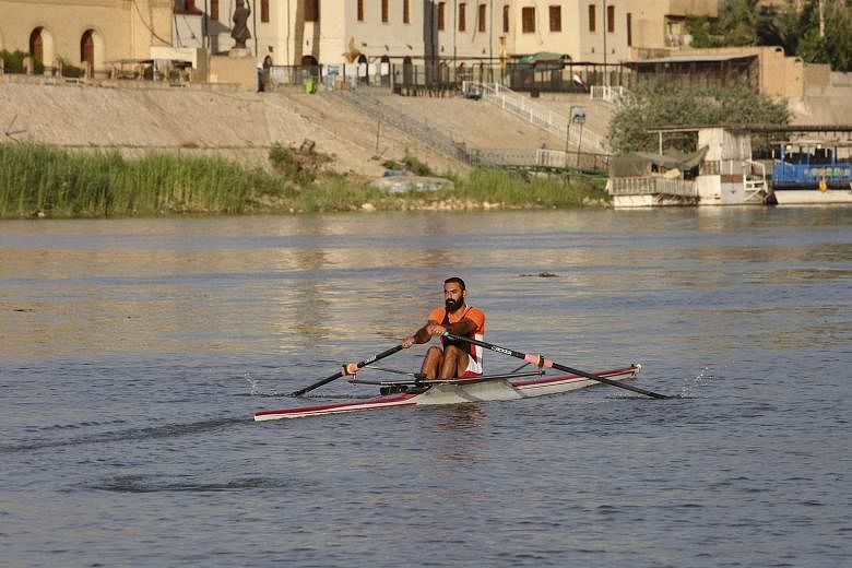 Iraqi rower Mohammed Riyadh Jasim training for the Olympics on the Tigris River. His French coach was unable to fly into Baghdad.