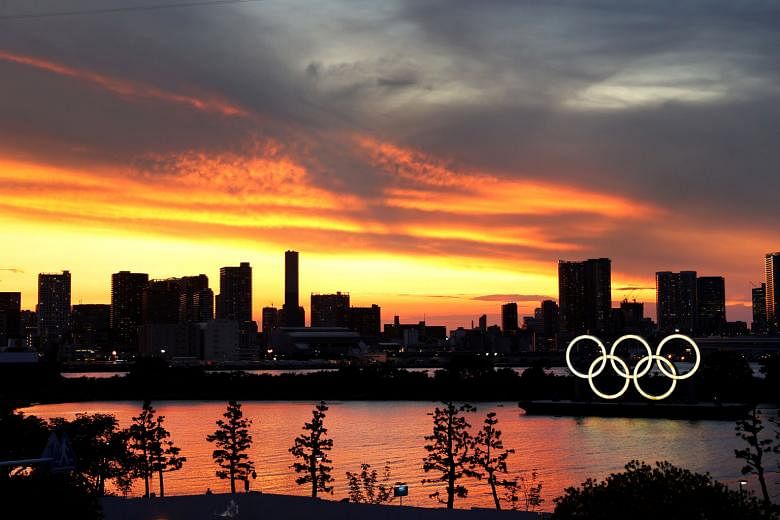 The Olympic rings are seen in front of the Tokyo skyline during sunset on Tuesday, three days ahead of the official opening of the 2020 Summer Games.