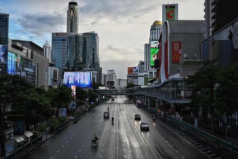 Commuters at Ratchaprasong intersection in Bangkok on July 12, the first day of stricter lockdown curbs to contain the spread of the coronavirus. The tougher measures have caused economic activity in Thailand to plummet to levels close to those reach