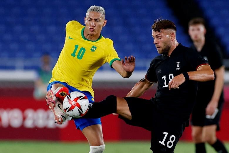 Brazil's Richarlison (left) challenging for the ball with Eduard Loewen of Germany during their Olympic match yesterday. The Brazilians won 4-2.