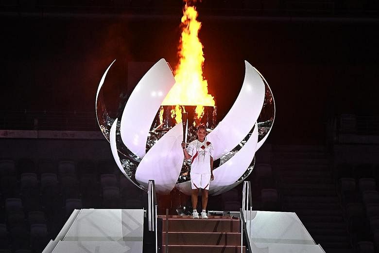 Drones forming the shape of the Earth in the Tokyo Olympic Stadium towards the end of the opening ceremony. Tennis player Naomi Osaka after lighting the Olympic cauldron at the opening ceremony of the Tokyo Olympic Games yesterday.