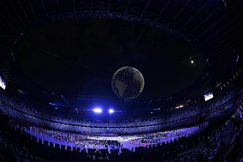 Drones forming the shape of the Earth in the Tokyo Olympic Stadium towards the end of the opening ceremony. Tennis player Naomi Osaka after lighting the Olympic cauldron at the opening ceremony of the Tokyo Olympic Games yesterday.