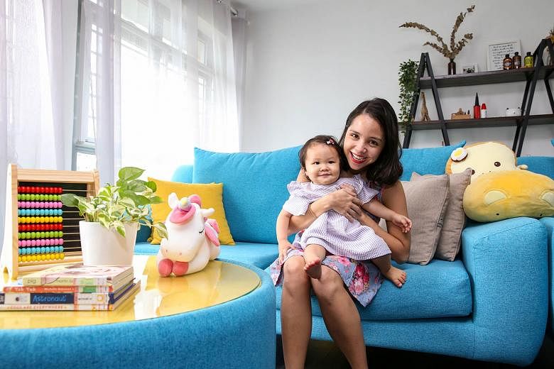 Ms Christel Goh (above), who plunged back into work after giving birth last July, says she enjoys being able to nurse and soothe baby Fayth by being close to her at home. 