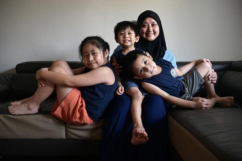 Front-line worker Siti Aida Mohd Samudi (above) with her children (from left) Aleena, seven; Ahnaf, two; and Adam, five. She nursed all of them and continued breastfeeding Ahnaf after getting her Covid-19 jabs in February. 
