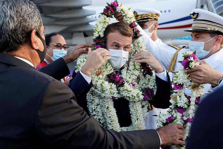 French President Emmanuel Macron being greeted with garlands after landing at French Polynesia's Faa'a International Airport last Saturday.