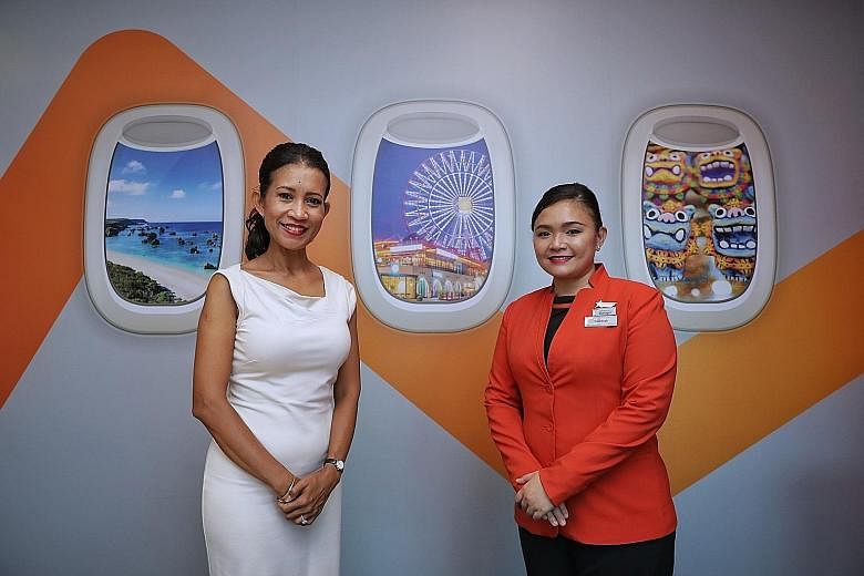 Scoot flight steward Jimmy Pung, 37, returned to flying in December after working for nine months as a community service executive. Jetstar Asia flight stewardess Raudhah Rihat (right), 41, hopes leisure travel will return soon. With her is flight st